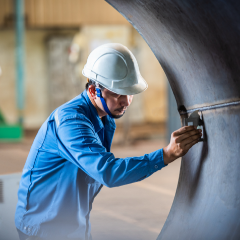 Man in blue work coat and white hard hat during CWI training in Austin, Texas